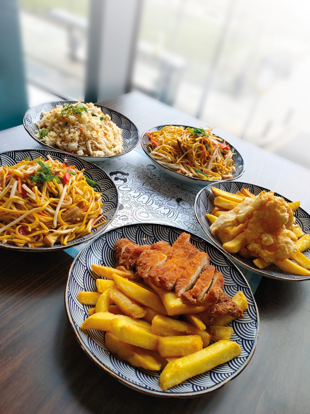 Several plates of Asian food on a table